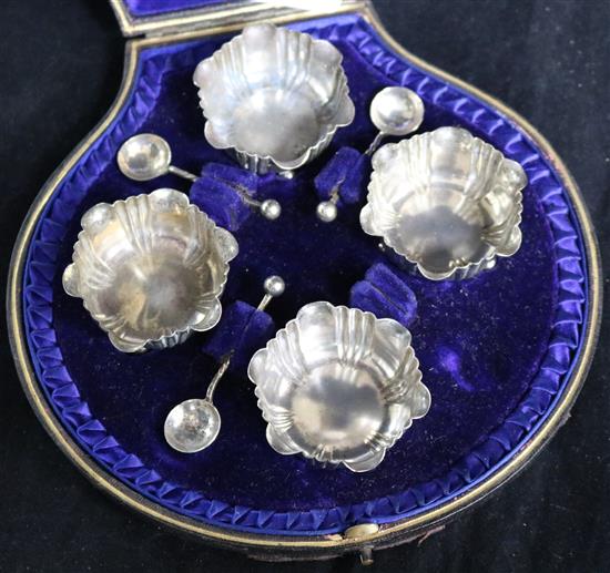 A cased set of four late Victorian silver salts, with three (ex 4) spoons.